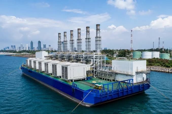 A floating power barge moored at a coastal terminal