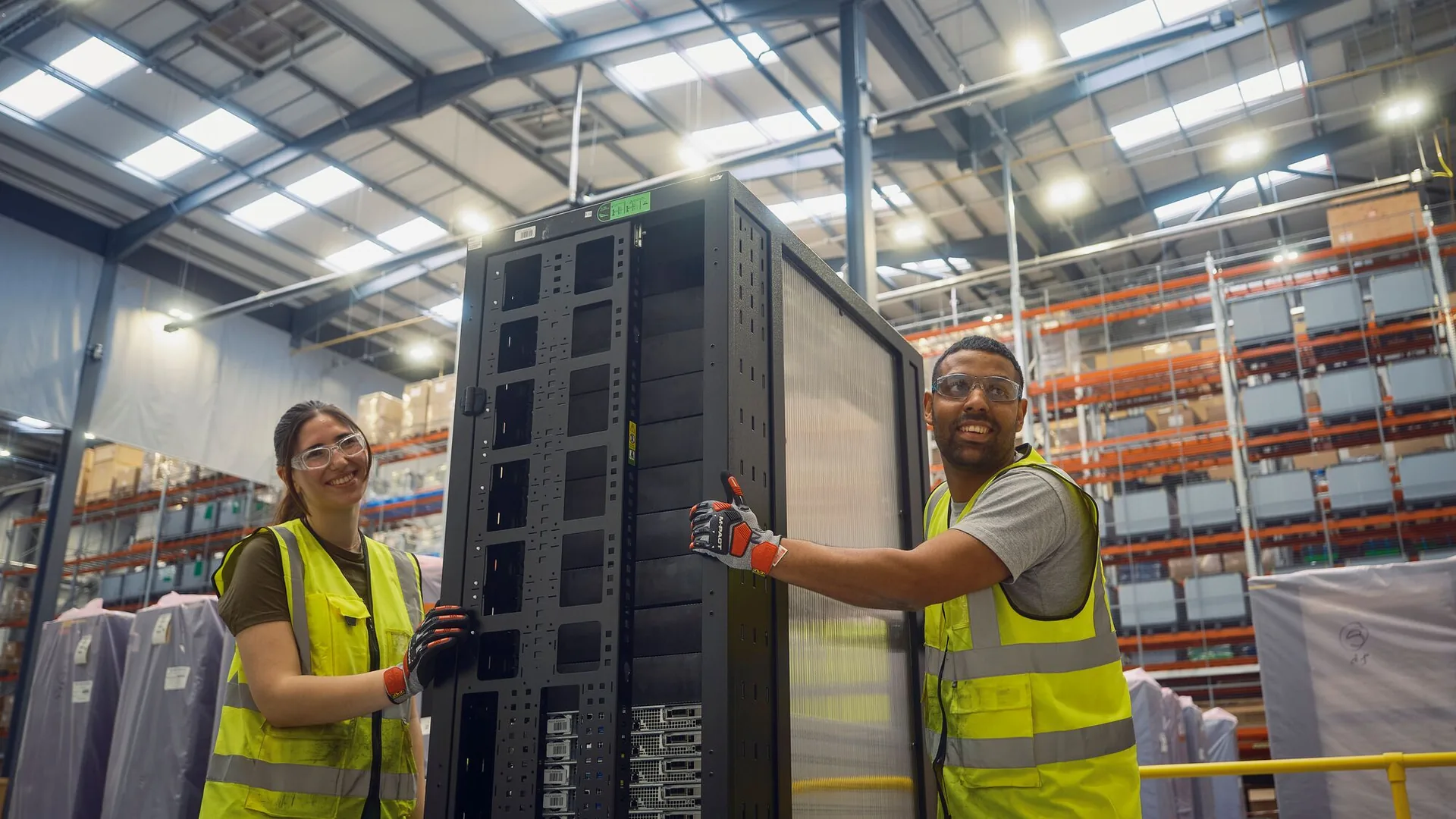 Logistics workers move a server rack through a fulfilment facility