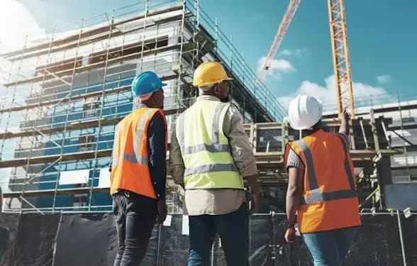 Construction crew in protective gear reviewing a build site, the industry Kenya's data centre careers are built on