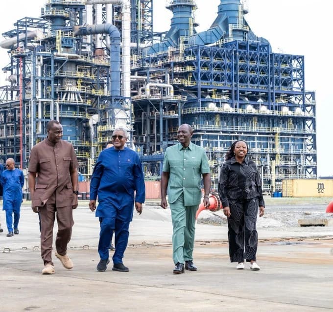 President William Ruto and Aliko Dangote walking with a delegation past refinery structures at the Dangote Petroleum Refinery in Lekki, Nigeria