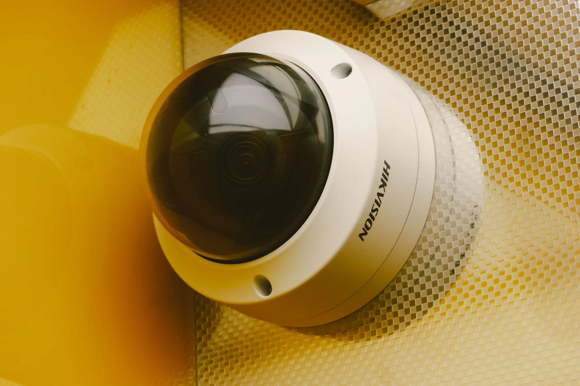 A surveillance camera mounted above a data centre corridor