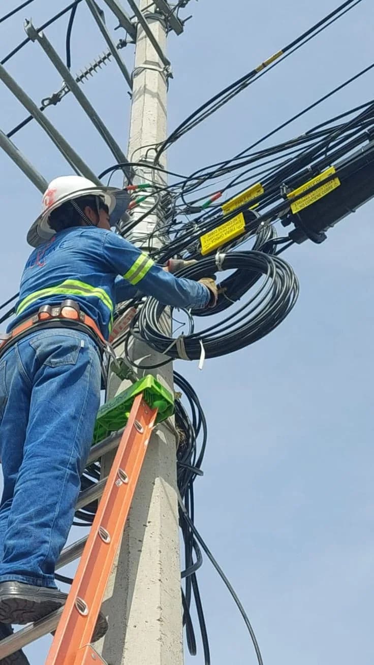 Grid technician working on overhead power distribution lines