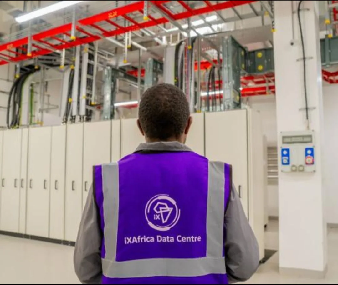 An iXAfrica technician standing in front of switchgear cabinets inside the facility's electrical room