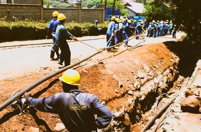 Kenya Power crews installing power cables along a street trench