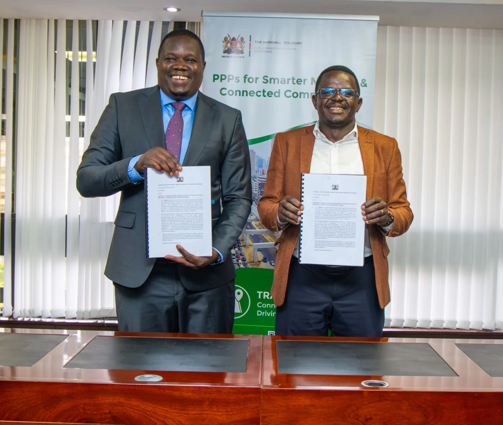 KoTDA and National Treasury PPP Directorate officials holding the signed funding agreement documents