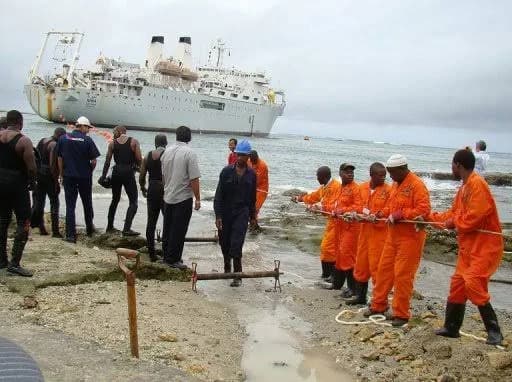Crews hauling a submarine cable ashore at Mombasa