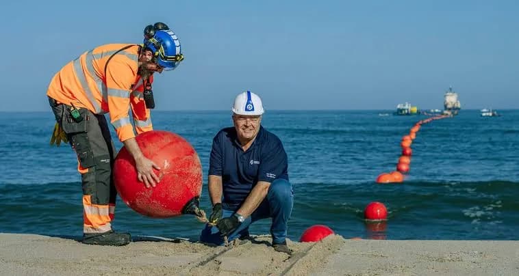 Landing crew securing a submarine cable buoy on the beach