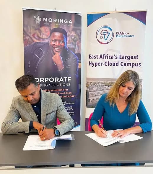 iXAfrica and Moringa School representatives signing a partnership