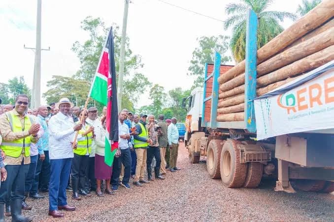 Officials at a REREC electricity pole handover in rural Kenya