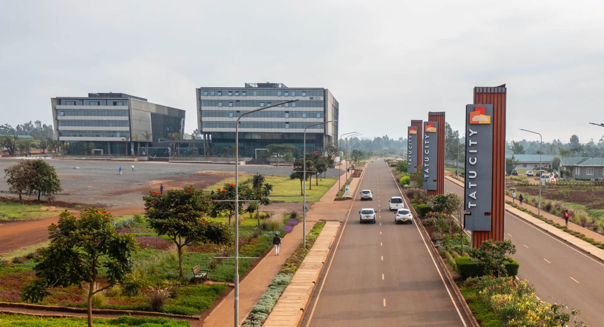 Tatu City boulevard with Tatu City signage and office buildings under construction