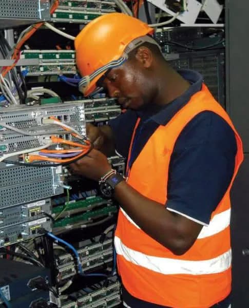 Engineer working at server racks in a Kenyan facility